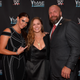 Ronda Rousey photographed with two large fans.